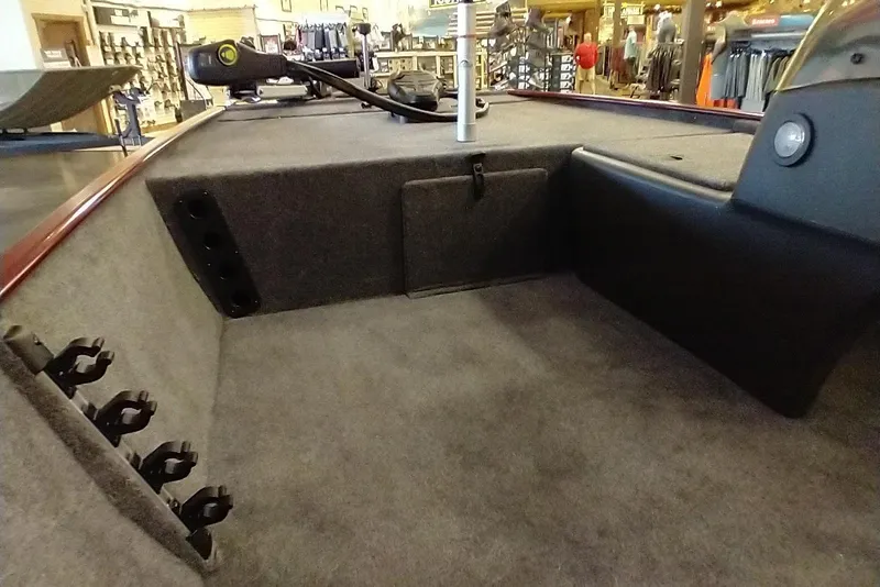 Slide: The Image of 2026 Tracker Bass Tracker Classic XL boat interior with rod holders and carpeted deck. - 7