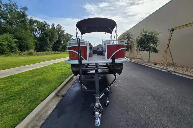 Slide: The Image of 2026 Sun Tracker SportFish 20 DLX pontoon boat on trailer, parked outdoors. - 52