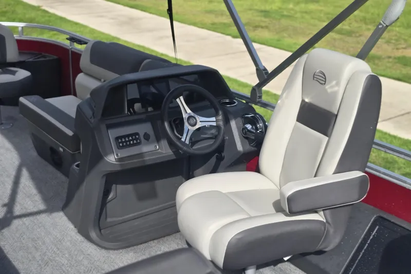 Slide: The Image of 2026 Sun Tracker SportFish 20 DLX boat interior with steering wheel and comfortable seating. - 57