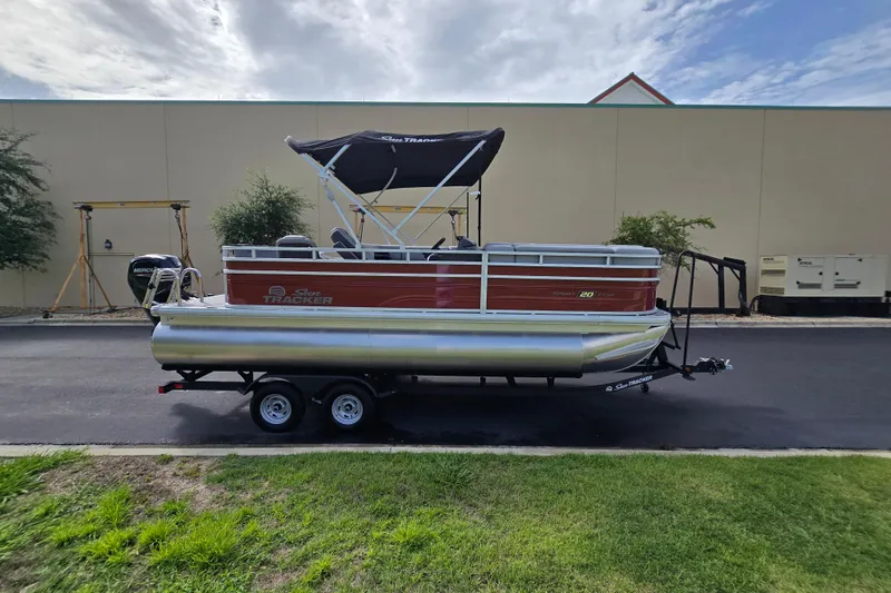 Slide: The Image of 2026 Sun Tracker SportFish 20 DLX pontoon boat on trailer, parked outdoors. - 59