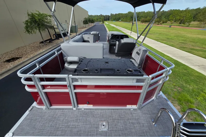 Slide: The Image of 2026 Sun Tracker SportFish 20 DLX pontoon boat with red exterior and spacious seating. - 60
