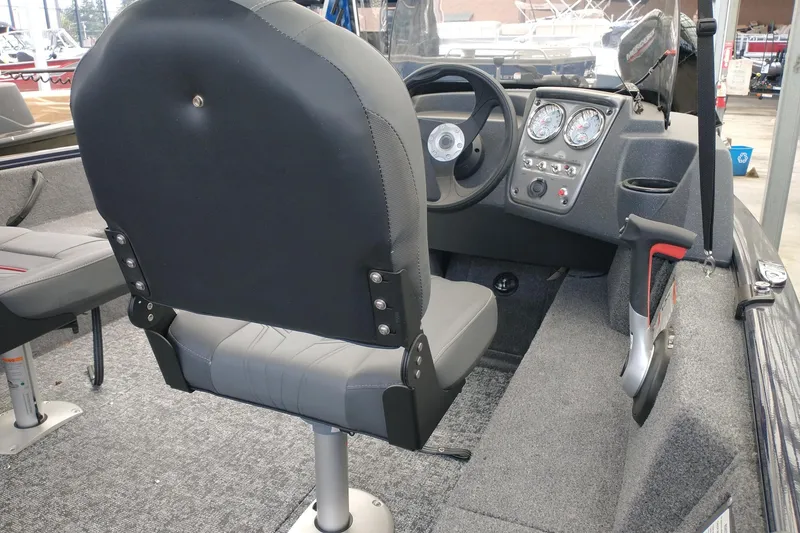 Slide: The Image of Interior of 2026 Tracker Super Guide V-16 SC boat with steering console and seating. - 3