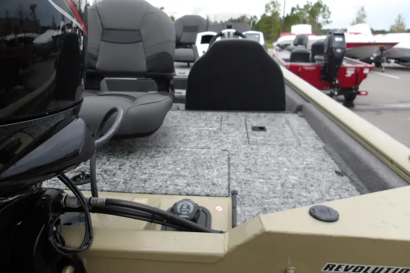 Slide: The Image of 2026 Tracker Pro Team 175 boat interior with seating and motor, parked outdoors. - 19