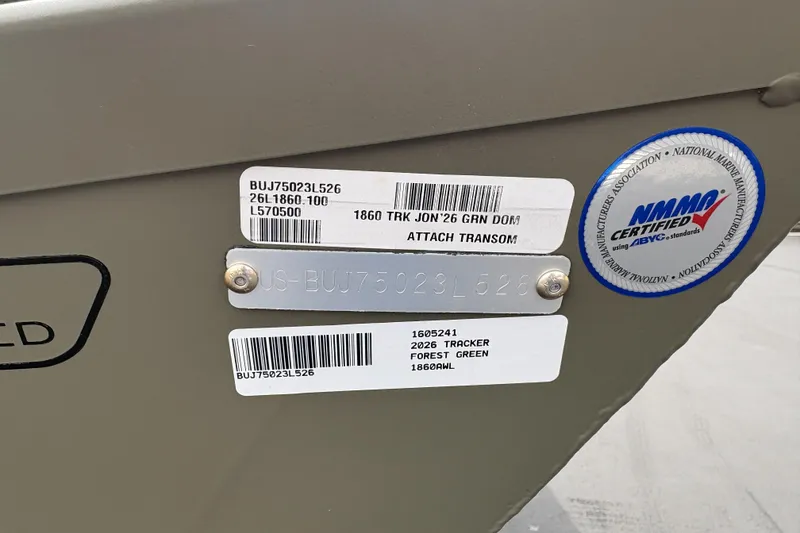 Slide: The Image of 2026 Tracker Grizzly 1860 Utility boat identification labels and NMMA certification sticker. - 27