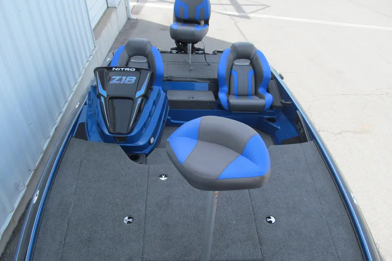 Slide: The Image of 2026 Nitro Z18 Pro boat interior with blue and gray seating, showcasing spacious deck design. - 101