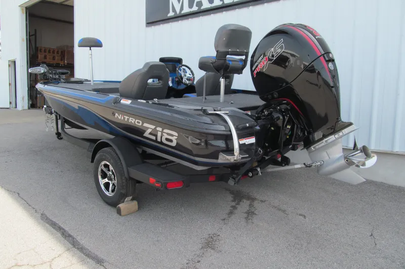 Slide: The Image of 2026 Nitro Z18 Pro boat with powerful outboard motor, parked outside a building. - 94