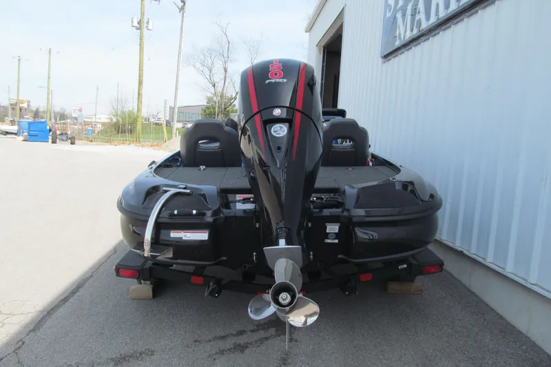 Slide: The Image of 2026 Nitro Z18 Pro boat with powerful outboard motor, parked outside a marine shop. - 95