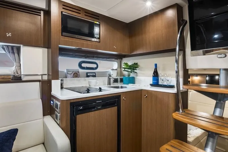 Slide: The Image of Manufacturer Provided Image: Modern kitchen area in 2021 Sea Ray Sundancer 350 Coupe yacht. - 24