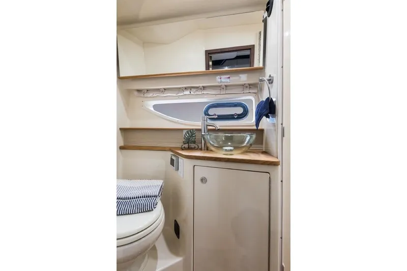 Slide: The Image of Manufacturer Provided Image: 2021 Sea Ray Sundancer 350 Coupe bathroom with modern sink and porthole window. - 28