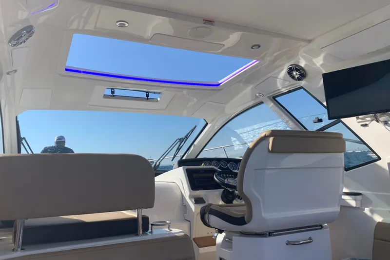 Slide: The Image of Interior of 2021 Sea Ray Sundancer 350 Coupe with modern helm and seating. - 4