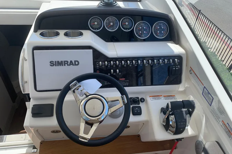 Slide: The Image of 2021 Sea Ray Sundancer 350 Coupe helm with Simrad display and controls. - 5