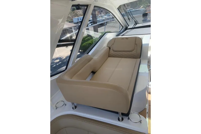 Slide: The Image of Luxurious seating on 2021 Sea Ray Sundancer 350 Coupe yacht, featuring beige upholstery. - 6