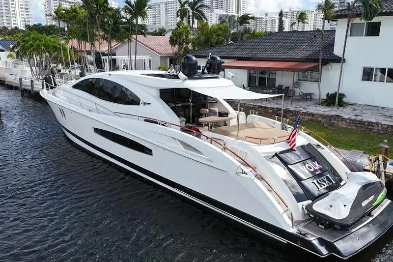 Slide: The Image of 2009 Lazzara LSX 75 luxury yacht docked by waterfront homes, featuring sleek design and modern amenities. - 11