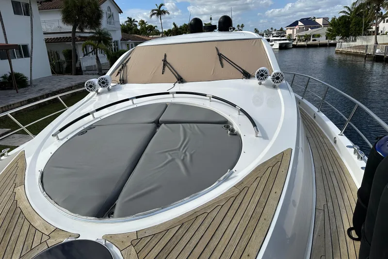 Slide: The Image of 2009 Lazzara LSX 75 yacht with sleek deck and luxurious design in a marina setting. - 15