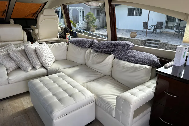 Slide: The Image of Luxurious interior of 2009 Lazzara LSX 75 yacht with white leather seating and large windows. - 21