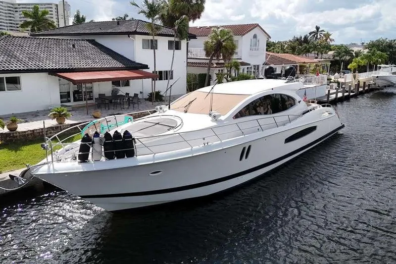 Slide: The Image of 2009 Lazzara LSX 75 yacht docked by waterfront homes, sunny day. - 7