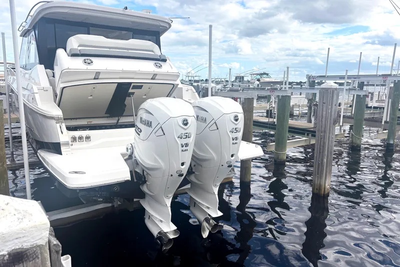 Slide: The Image of 2024 Regal 36 XO boat with twin Yamaha 450 V8 engines docked at marina. - 8