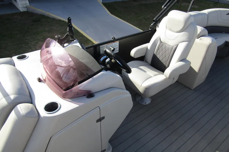 Slide: The Image of 2022 Starcraft SLS 5 boat interior with steering wheel and plush seating. - 11