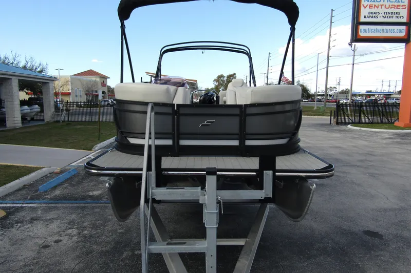 Slide: The Image of 2022 Starcraft SLS 5 pontoon boat on trailer at dealership. - 2