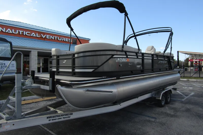 Slide: The Image of 2022 Starcraft SLS 5 pontoon boat on trailer at Nautical Ventures dealership. - 3