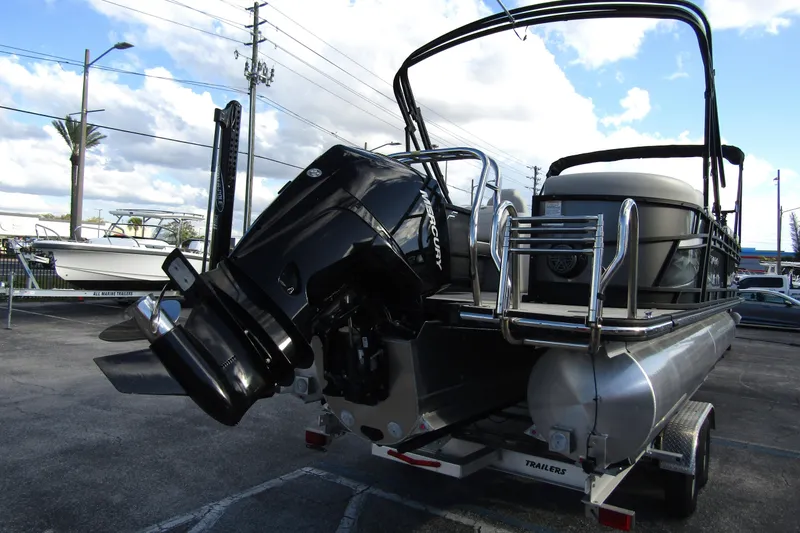 Slide: The Image of 2022 Starcraft SLS 5 pontoon boat with Mercury outboard motor on trailer. - 6