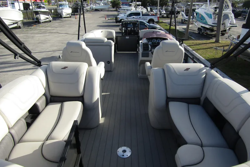 Slide: The Image of 2022 Starcraft SLS 5 pontoon boat interior with luxurious seating and modern dashboard. - 7
