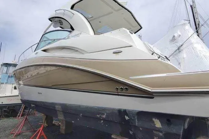 The Image of 2008 Cruisers Yachts 360 Express boat on stands, side view, outdoors. - 0