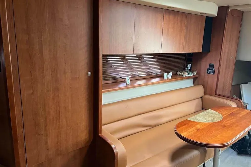 Slide: The Image of Interior of 2008 Cruisers Yachts 360 Express with wood paneling and leather seating. - 4