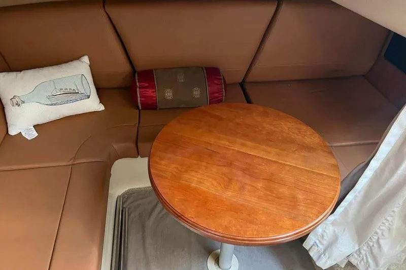 Slide: The Image of Interior of 2008 Cruisers Yachts 360 Express with brown seating and wooden table. - 6