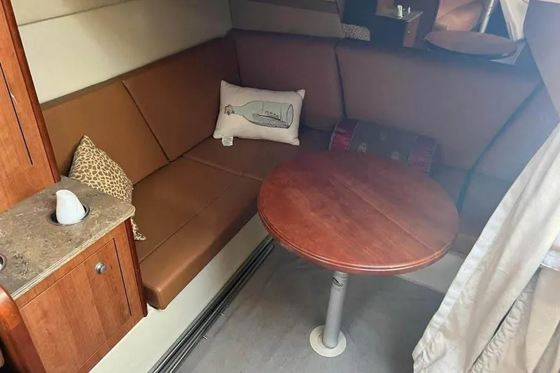 Slide: The Image of 2008 Cruisers Yachts 360 Express interior with brown seating and wooden table. - 7