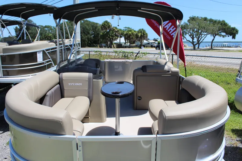 The Image of 2026 Sylvan Mirage 820 PARTY FISH pontoon boat with beige seating and table. - 0