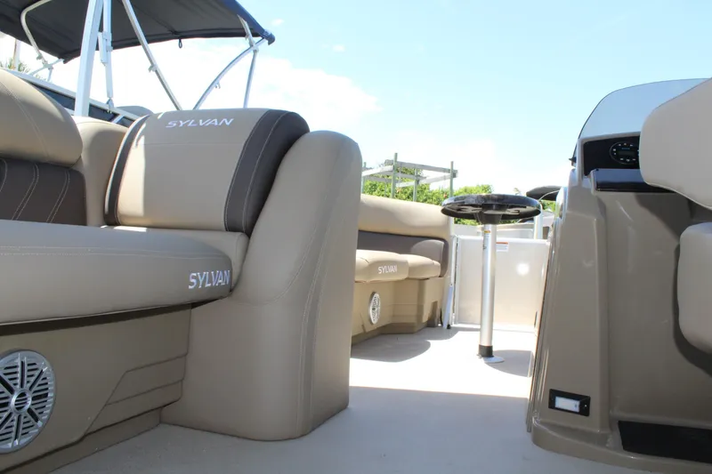 Slide: The Image of 2026 Sylvan Mirage 820 PARTY FISH interior with beige seating and table. - 11