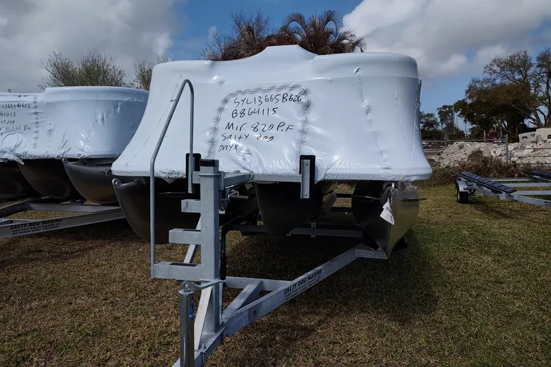 Slide: The Image of 2026 Sylvan Mirage 820 PARTY FISH boat wrapped in protective cover on trailer. - 14