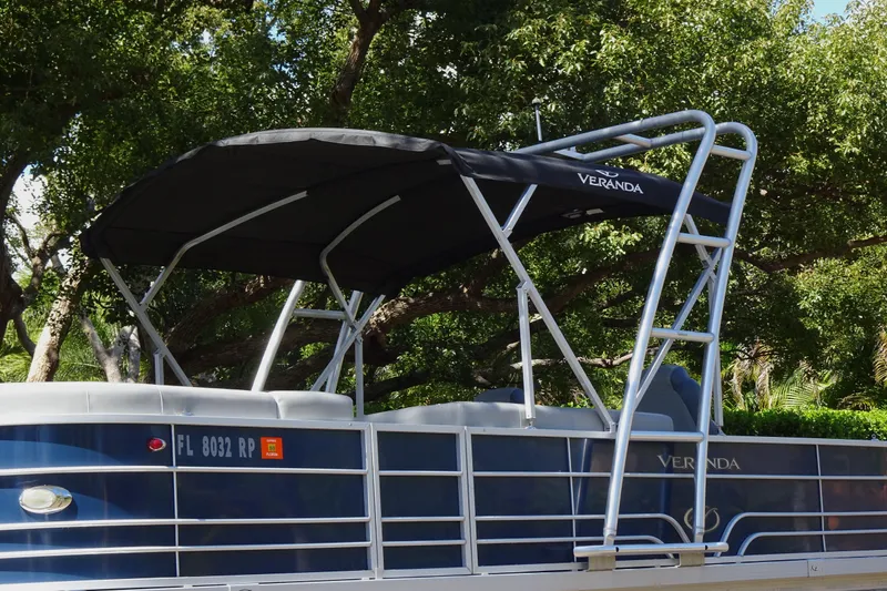 Slide: The Image of 2018 Veranda VF22TT pontoon boat with canopy, parked under trees. - 10
