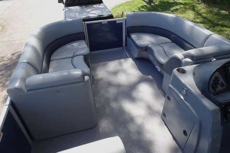 Slide: The Image of 2018 Veranda VF22TT pontoon boat interior with gray seating and console. - 12