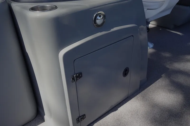 Slide: The Image of 2018 Veranda VF22TT boat interior with storage compartment and cup holder. - 22