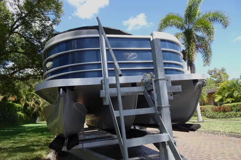 Slide: The Image of 2018 Veranda VF22TT pontoon boat on trailer, surrounded by lush greenery. - 6
