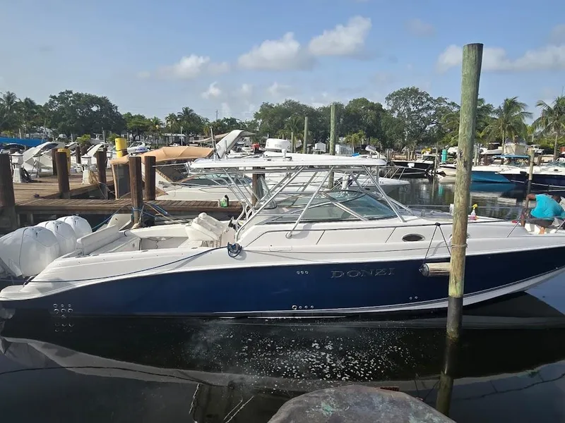 The Image of 2008 Donzi 38 ZSF boat docked at a marina, featuring sleek design and blue hull. - 0