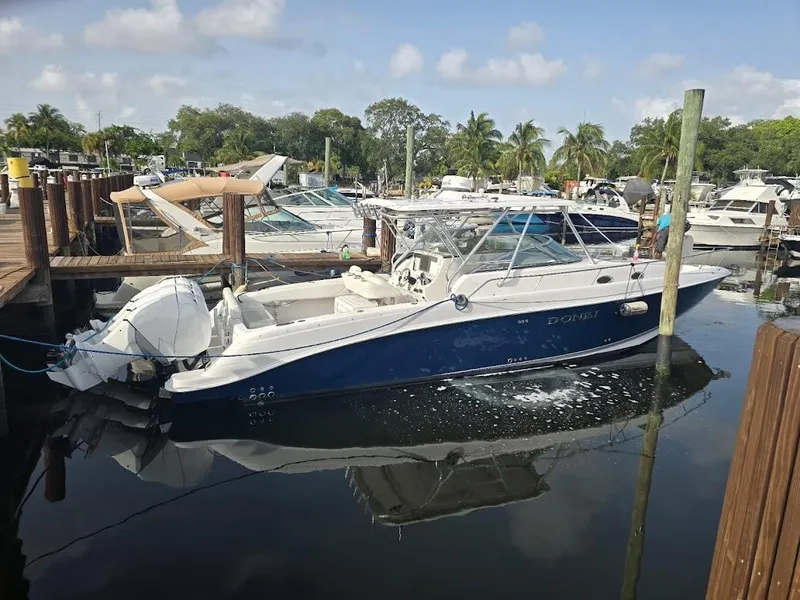 Slide: The Image of 2008 Donzi 38 ZSF boat docked at a marina with clear skies. - 2