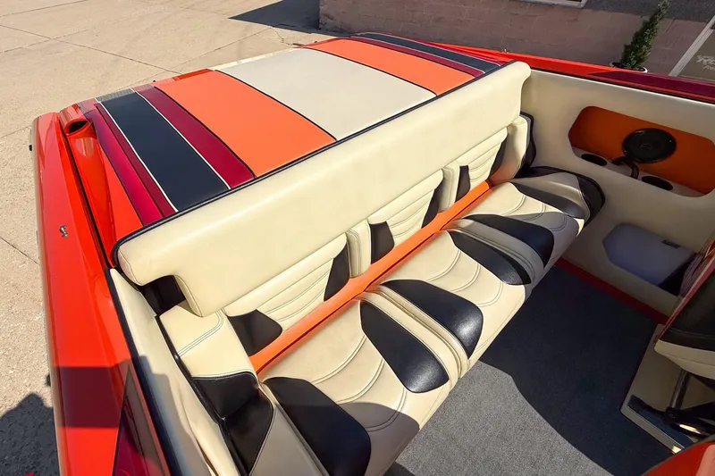 Slide: The Image of 2012 DCB 28 Extreme boat interior with vibrant, striped upholstery and spacious seating. - 12