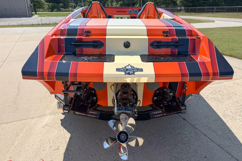 Slide: The Image of 2012 DCB 28 Extreme boat with vibrant striped design and dual propellers. - 6