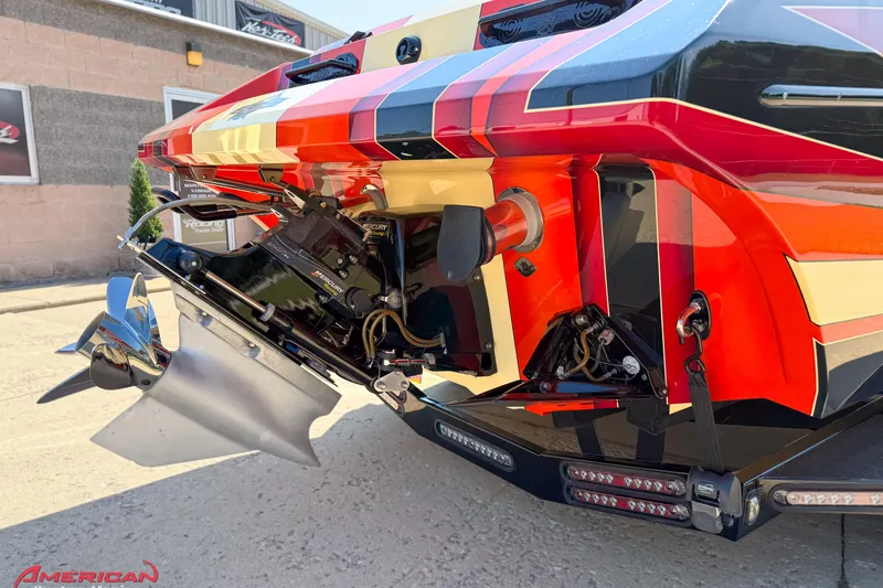 Slide: The Image of Rear view of a 2012 DCB 28 Extreme boat with vibrant graphics and Mercury engine. - 7