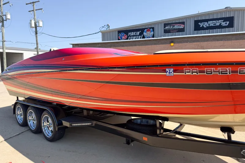 Slide: The Image of 2012 DCB 28 Extreme boat with vibrant red and orange design on a trailer. - 8