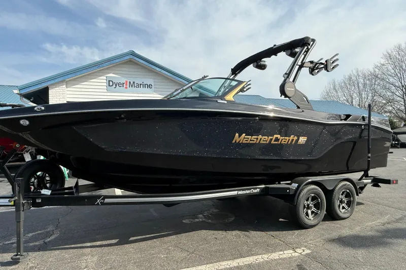 The Image of 2026 MasterCraft XT24 boat on trailer at Dyer Marine dealership. - 0