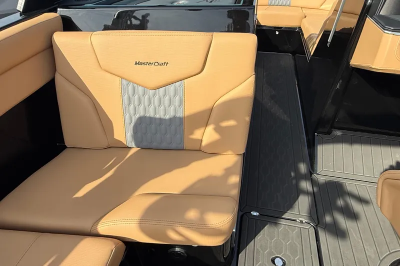 Slide: The Image of 2026 MasterCraft XT24 boat interior with tan and gray seating, showcasing luxury design. - 11