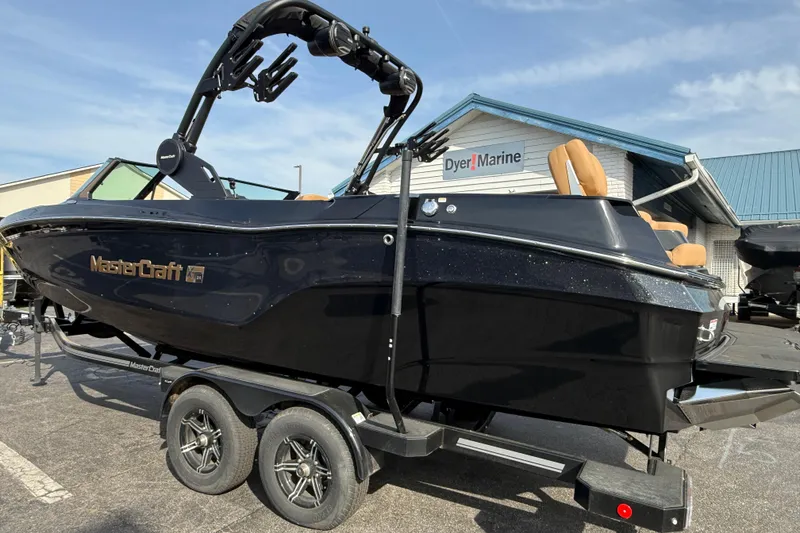 Slide: The Image of 2026 MasterCraft XT24 boat on trailer at Dyer Marine dealership. - 2
