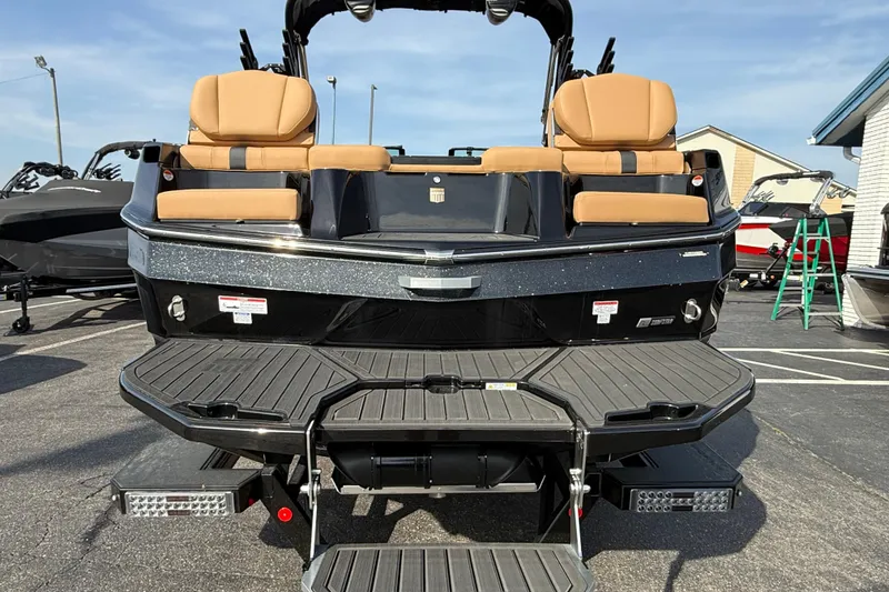Slide: The Image of 2026 MasterCraft XT24 boat rear view with tan seats and swim platform. - 3