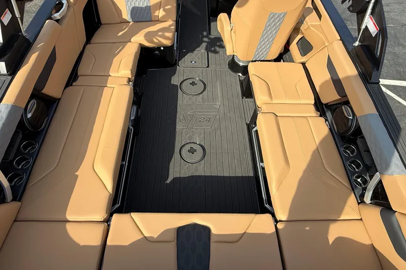 Slide: The Image of 2026 MasterCraft XT24 boat interior with tan seating and black flooring. - 5