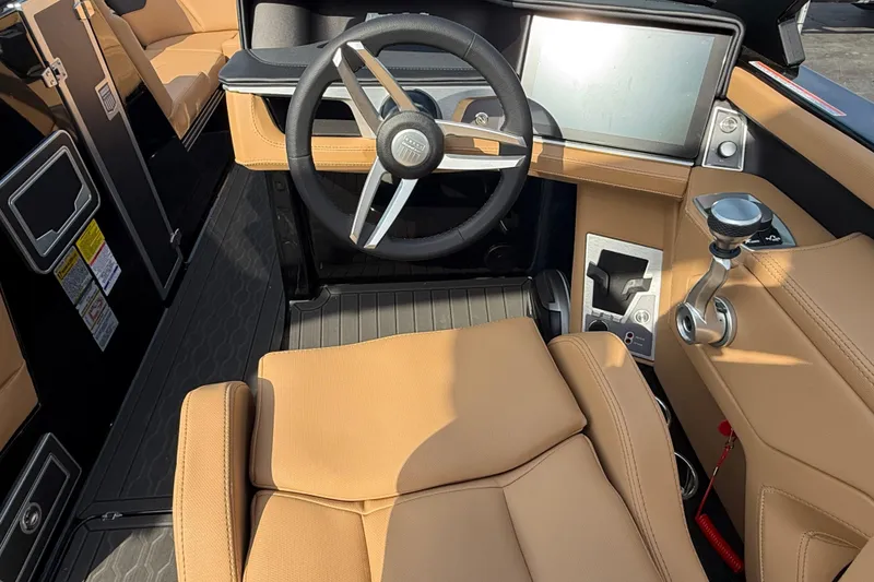 Slide: The Image of 2026 MasterCraft XT24 boat interior with tan seating and modern steering console. - 6