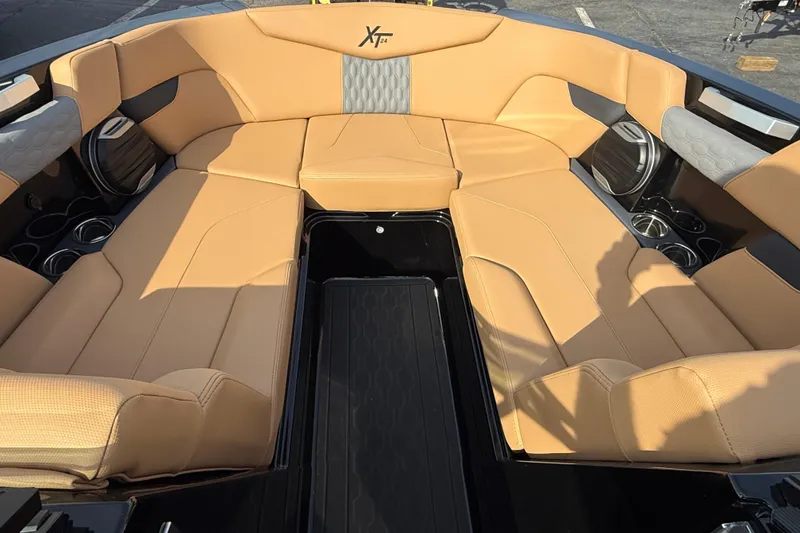 Slide: The Image of Luxurious interior of 2026 MasterCraft XT24 boat with tan seating and cup holders. - 7